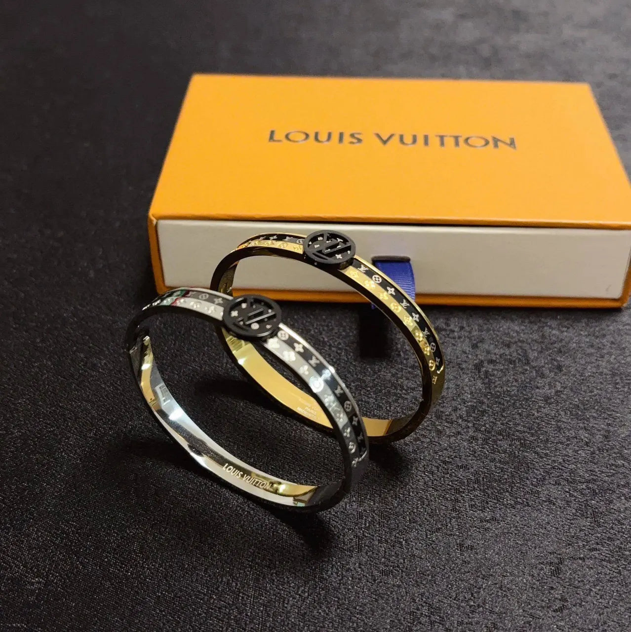 Gold and black designer bangle bracelet on wrist - Hình 9