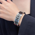 Silver-Tone Logo Bracelet on Wrist