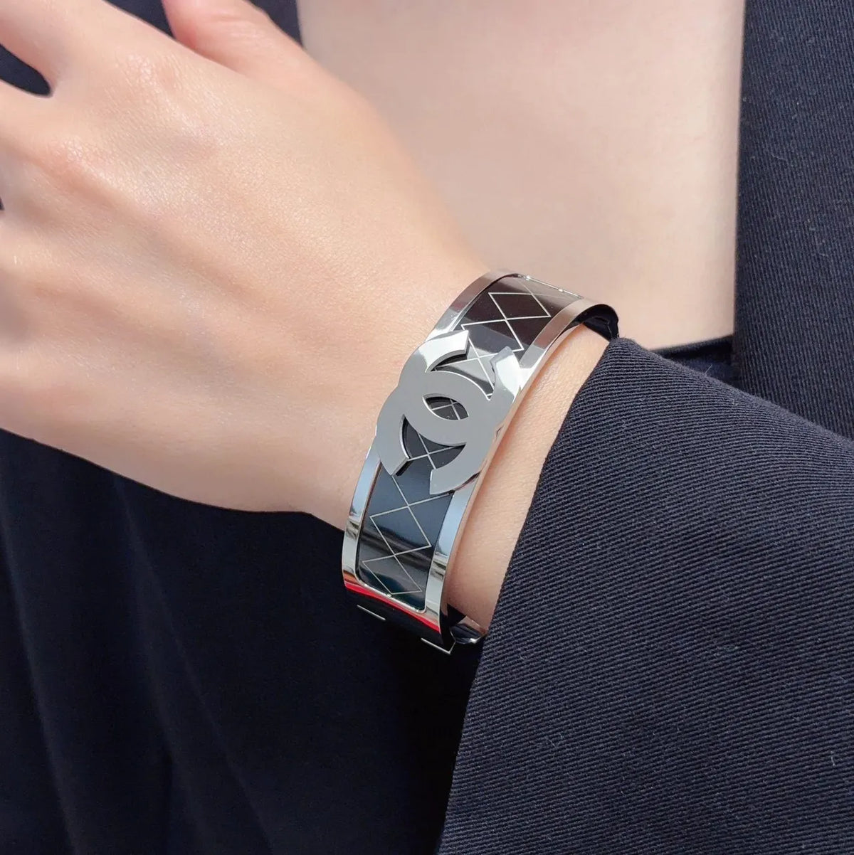 Silver-Tone Logo Bracelet on Wrist